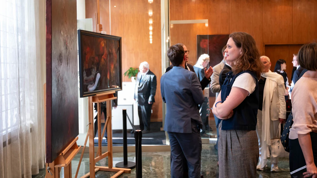 A woman looking at a painting.