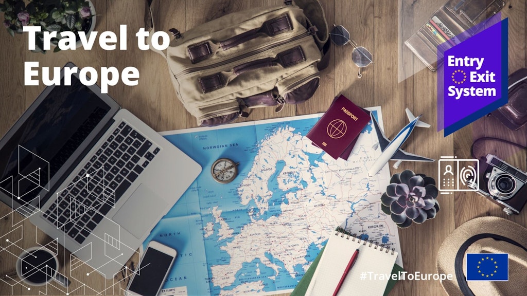 A map of Europe, a laptop, passport and travel artefacts.