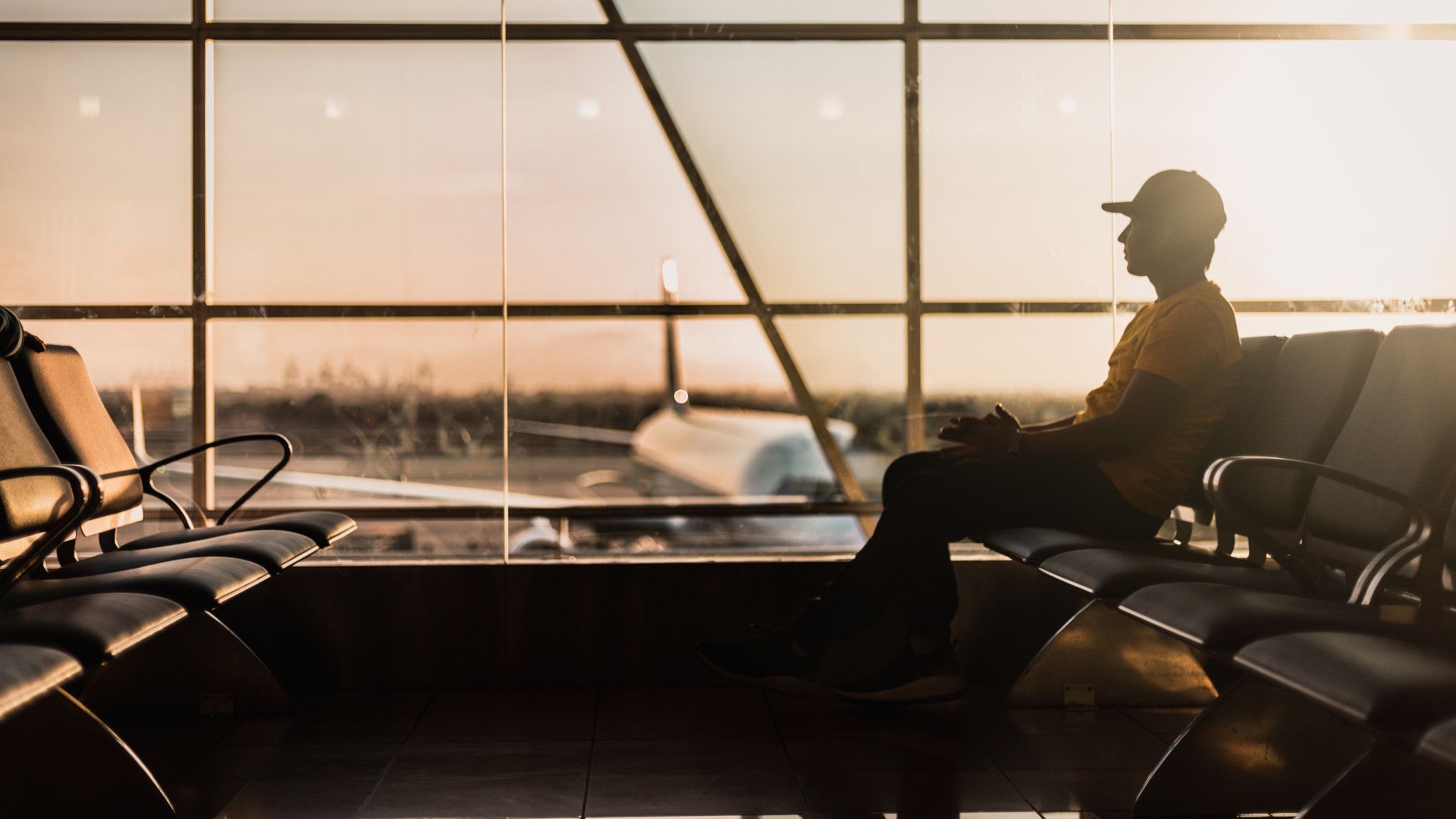Man at airport waiting for a flight.